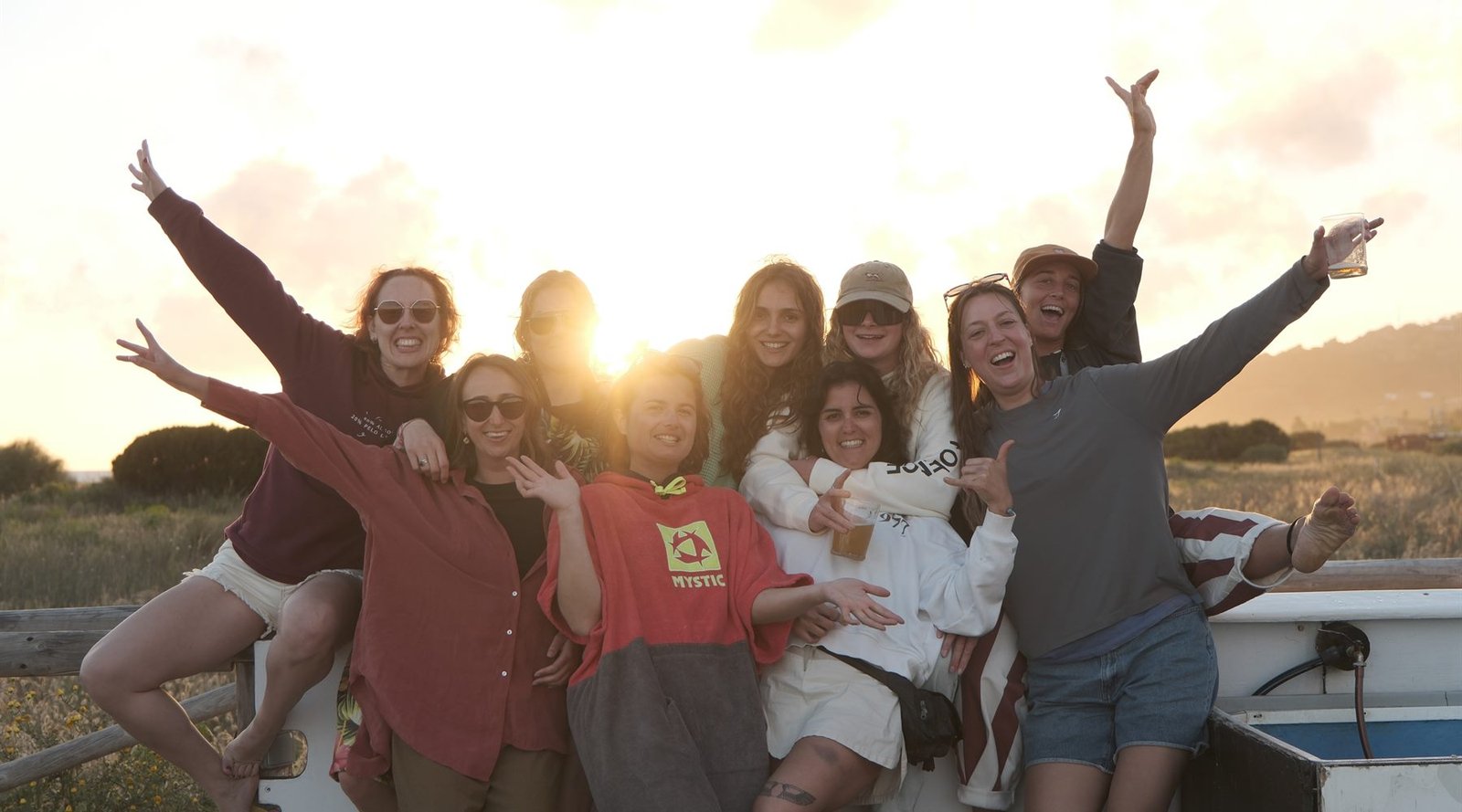 WeGirls group smiling together at sunset in Tarifa