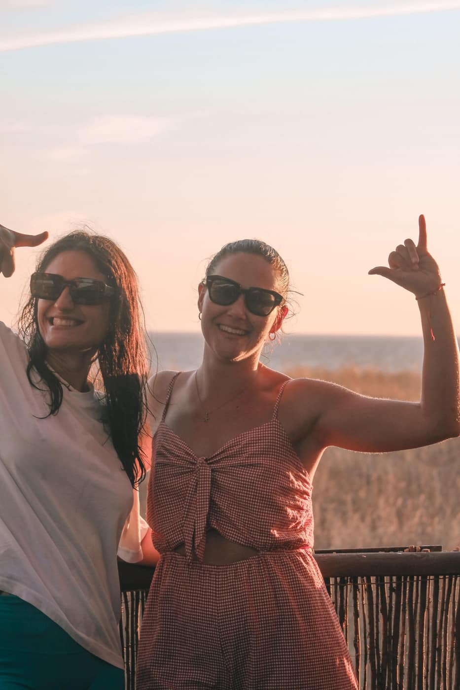Two women smiling together on the beach in Tarifa