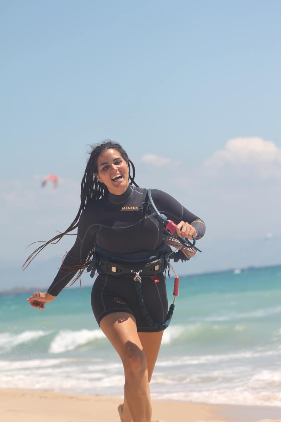 Lauri smiling on the beach after a kite session